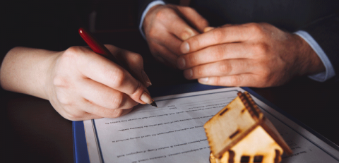 Couple signing documents - inheritance tax insurance