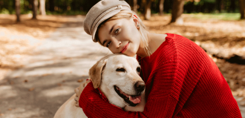 A girl hugging her dog - pet insurance