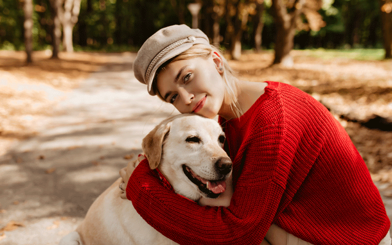 A girl hugging her dog - pet insurance